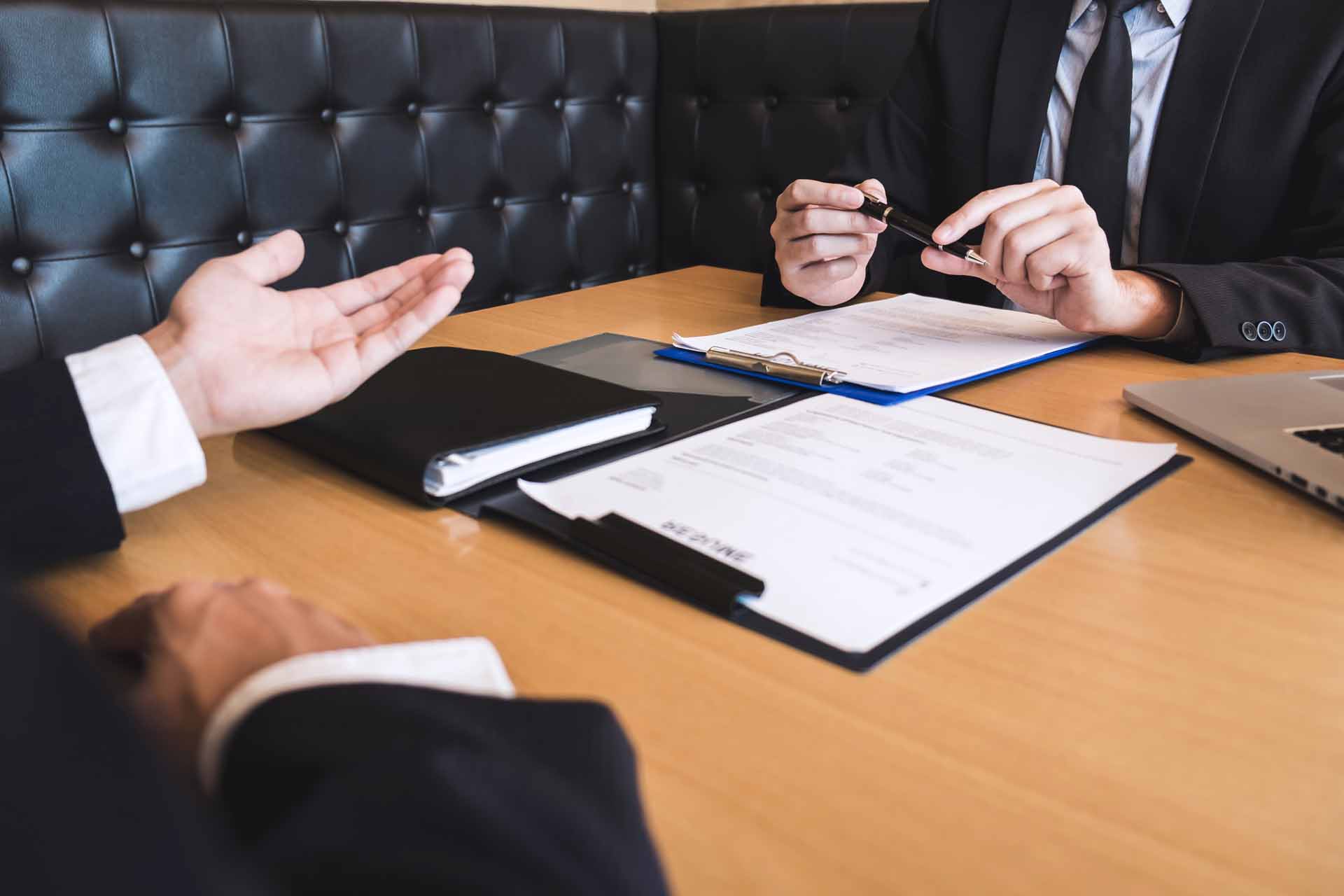 Employer or recruiter holding reading a resume during about his